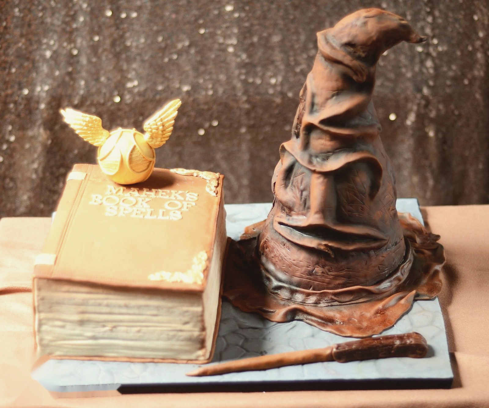 The Sorting Hat, a spellbook and a wand, all in cake