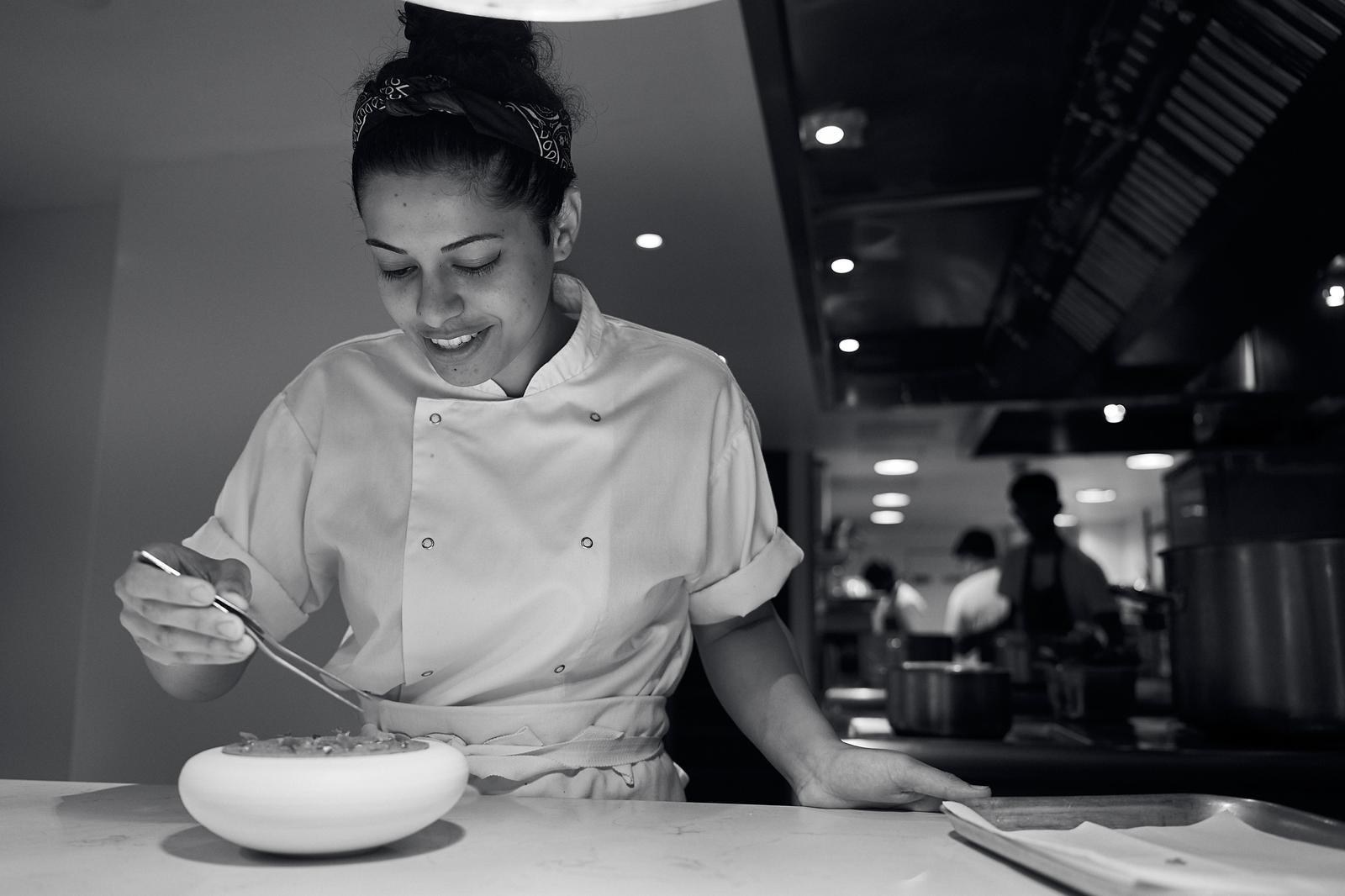 Apeksha Kabbe plating a dessert in a restaurant kitchen